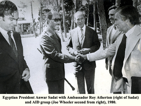 Egyptian President Anwar Sadat with Ambassador Roy Atherton (right of Sadat) and AID group (Joe Wheeler second from right), 1980