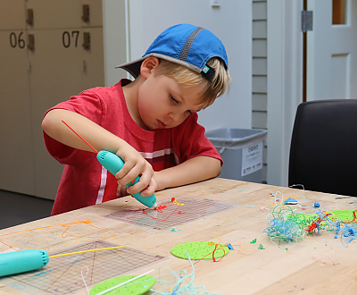 a child using a 3d pen background image