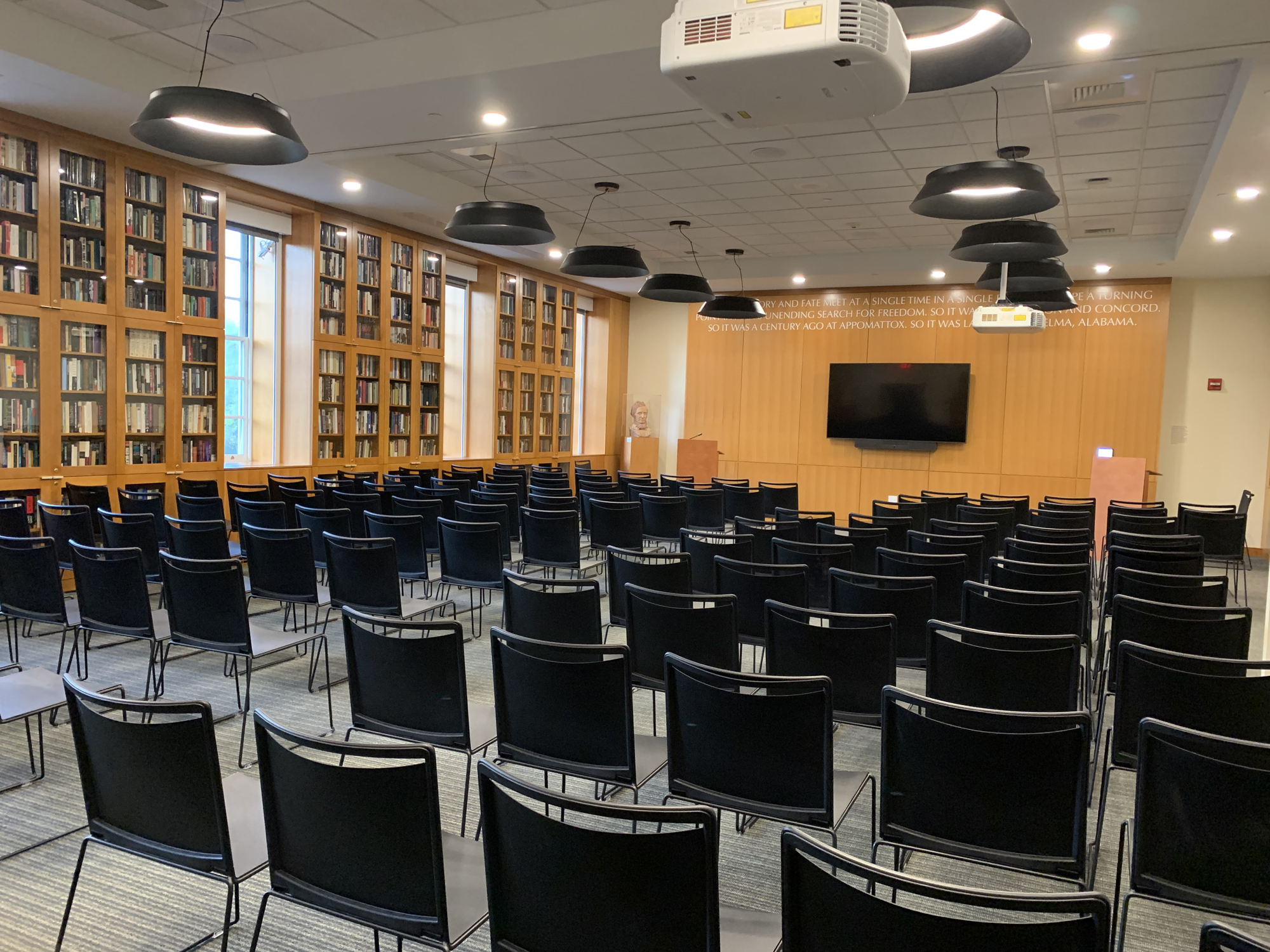 Rows of chairs face a television in the Goodwin forum.