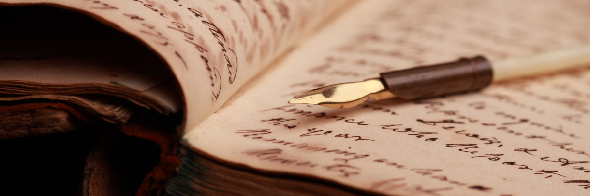 An image showing a calligraphy pen on aged paper.